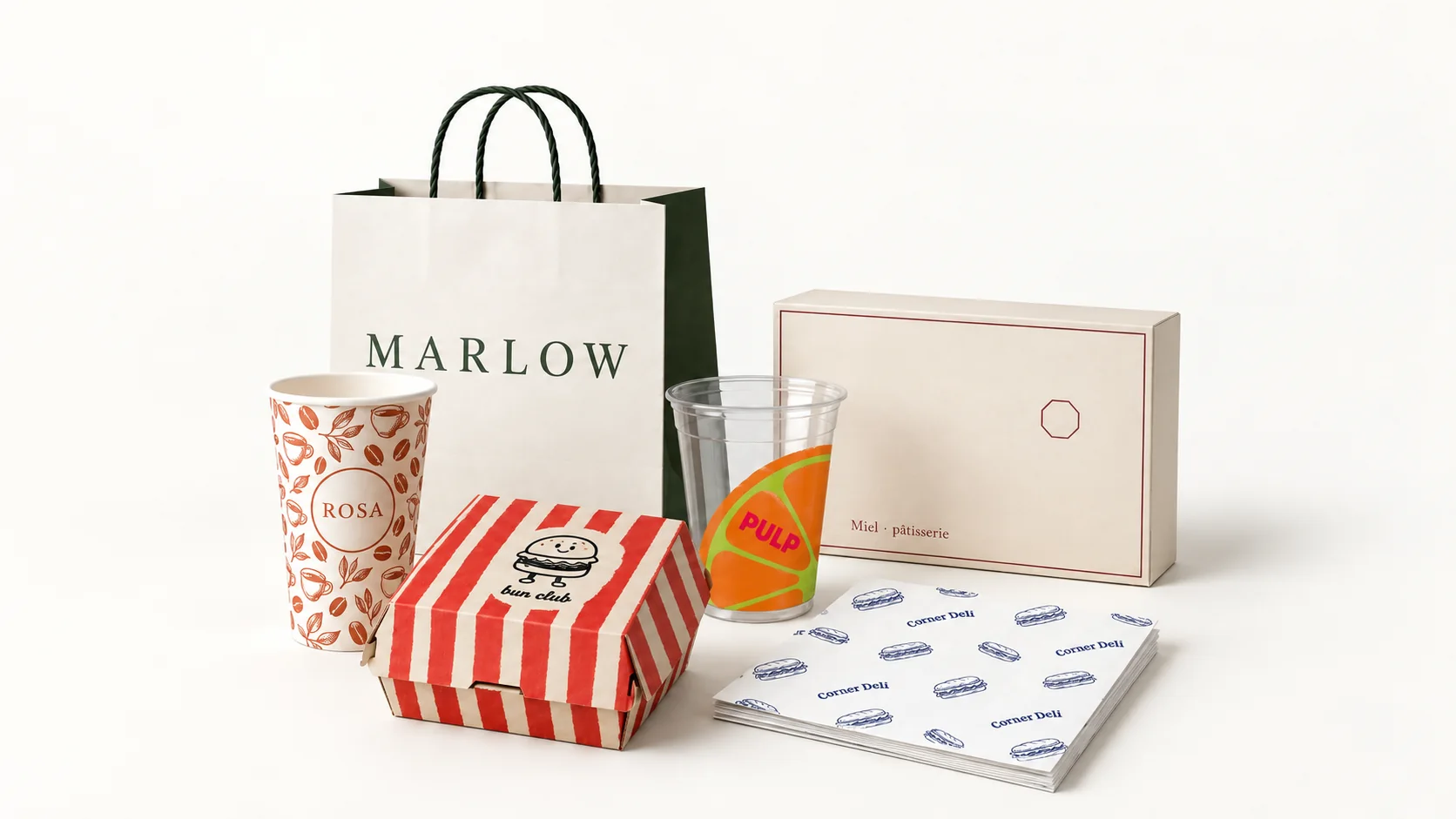 Illustrative collection of custom-printed packaging: a paper carrier bag, coffee cup, cold cup, burger box, pastry box and greaseproof sheets